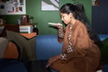 Young South Asian Woman Using Smartphone Voice Assistant on Sofa - PhotoDune Item for Sale