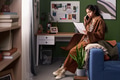 Young South Asian Woman Reading Document While Talking on Smartphone - PhotoDune Item for Sale