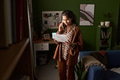 Young South Asian Woman Talking on Smartphone While Reading Documents - PhotoDune Item for Sale
