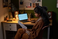 Young South Asian Woman Reviewing Printed Charts While Sitting at Desk - PhotoDune Item for Sale