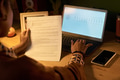 Woman Reviewing Document While Working on Laptop - PhotoDune Item for Sale