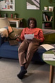 Young Indian Woman Studying Documents While Sitting on Sofa at Home - PhotoDune Item for Sale
