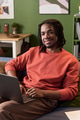 Portrait of Young Black Man Smiling While Using Laptop Indoors - PhotoDune Item for Sale