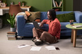 Young Black Man Sitting on Floor Using Laptop for Remote Work - PhotoDune Item for Sale