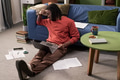 Young Black Man Sitting on Floor Studying with Laptop Looking Stressed - PhotoDune Item for Sale