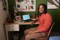 Portrait of Young Black Man Smiling While Working at Home Office Desk - PhotoDune Item for Sale