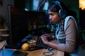 Young South Asian Woman Coding on Computer While Wearing Headphones - PhotoDune Item for Sale