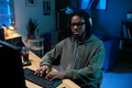 Young Black Man Wearing Headphones Working on Computer at Night - PhotoDune Item for Sale