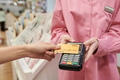 Young Woman Paying with Credit Card Using Contactless Terminal - PhotoDune Item for Sale
