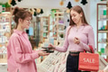 Young Woman Paying with Card While Shopping during Store Sale Event - PhotoDune Item for Sale