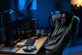 Young Black Man Relaxing While Coding on Computer Monitors at Night - PhotoDune Item for Sale