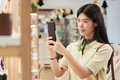 Young Asian Woman Using Smartphone Camera While Shopping Indoors - PhotoDune Item for Sale