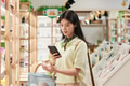 Young Asian Woman Comparing Product Information Using Smartphone - PhotoDune Item for Sale