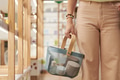 Young Woman Holding Shopping Basket in Modern Store Aisle - PhotoDune Item for Sale