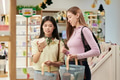 Young Asian Woman and Young Woman Shopping for Skincare Products - PhotoDune Item for Sale