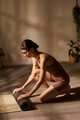 Young Adult Caucasian Woman Kneeling While Preparing Yoga Mat for Morning Practice - PhotoDune Item for Sale