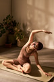 Young Adult Caucasian Woman Practicing Seated Yoga Stretching Indoors - PhotoDune Item for Sale