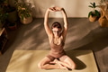 Young Adult Caucasian Woman Practicing Yoga Stretching on Exercise Mat Indoors - PhotoDune Item for Sale