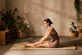 Young Adult Caucasian Woman Practicing Seated Forward Bend Yoga Indoors - PhotoDune Item for Sale