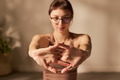 Young Adult Caucasian Woman Stretching Fingers during Indoor Yoga Practice - PhotoDune Item for Sale