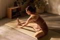 Young Adult Caucasian Woman Stretching on Yoga Mat during Morning Exercise - PhotoDune Item for Sale