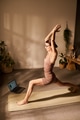 Young Adult Caucasian Woman Practicing Yoga Posing Indoors Using Laptop - PhotoDune Item for Sale