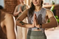 Young Adult Caucasian Woman Practicing Yoga Indoors with Hands in Namaste Pose - PhotoDune Item for Sale