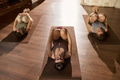 Young Adults Practicing Yoga Poses on Mats in Studio Setting - PhotoDune Item for Sale
