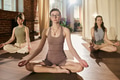 Young Caucasian Women Meditating Together during Yoga Class Indoors - PhotoDune Item for Sale