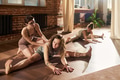 Young Caucasian Women Practicing Stretching Exercises during Yoga Class - PhotoDune Item for Sale