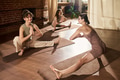Young Caucasian Women Practicing Yoga Stretches Together in Sunlit Studio - PhotoDune Item for Sale