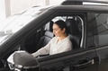 Beautiful young woman touching her new car with pleasure - PhotoDune Item for Sale