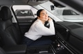Beautiful young woman touching her new car with pleasure - PhotoDune Item for Sale