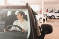 Beautiful young woman touching her new car with pleasure - PhotoDune Item for Sale