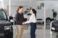 Portrait of a beautiful young couple choosing a new car at a car dealership - PhotoDune Item for Sale