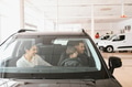 Family in a car dealership. Happy family choosing a new car in a showroom - PhotoDune Item for Sale