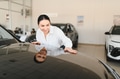 Beautiful young woman touching her new car with pleasure - PhotoDune Item for Sale