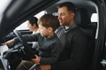 family choosing a car in dealership, they want the most comfortable and safe car - PhotoDune Item for Sale