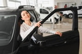 Lady in a car salon. Woman buying the car. In a white shirt - PhotoDune Item for Sale