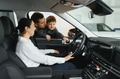 Family in a car dealership. Happy family choosing a new car in a showroom - PhotoDune Item for Sale
