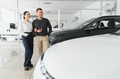 Portrait of a beautiful young couple choosing a new car at a car dealership - PhotoDune Item for Sale