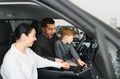 Happy family buying a new car at the car showroom - PhotoDune Item for Sale