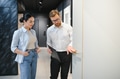 Shop assistant showing door to customer in hardware store - PhotoDune Item for Sale