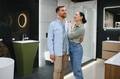 Happy couple choosing bathroom fixtures in plumbing store - PhotoDune Item for Sale