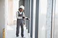 Construction worker sealing window frame in building under construction - PhotoDune Item for Sale