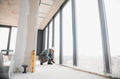 Construction worker installing window in modern office building - PhotoDune Item for Sale