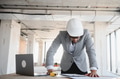 Arab architect reviewing blueprints on construction site - PhotoDune Item for Sale
