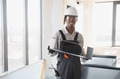 Construction worker carrying ventilation system piece in building site - PhotoDune Item for Sale
