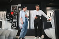 Salesman showing toilet features to customer in bathroom furniture store - PhotoDune Item for Sale