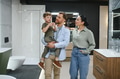 Family choosing bathroom fixtures in showroom with father holding son - PhotoDune Item for Sale